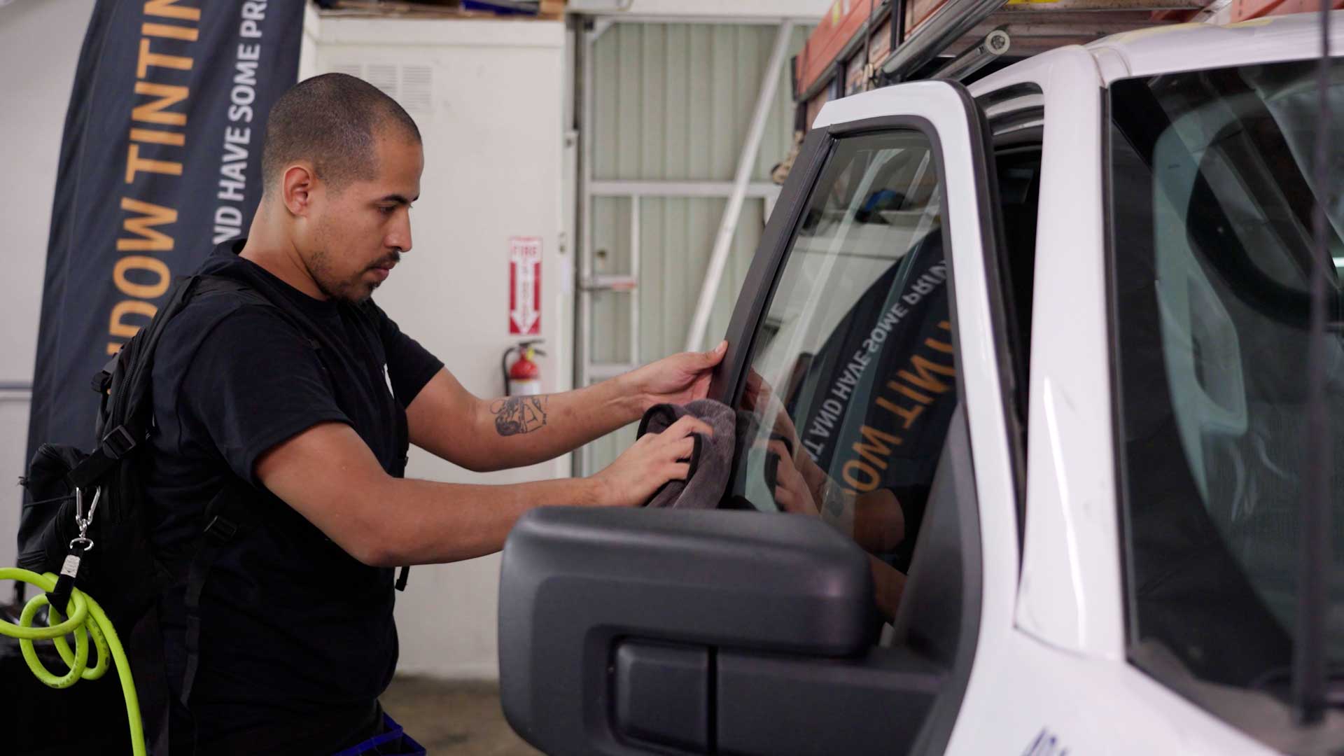 Skilled Vehicle Window Tinting being cleaned after tinting in Blue Island