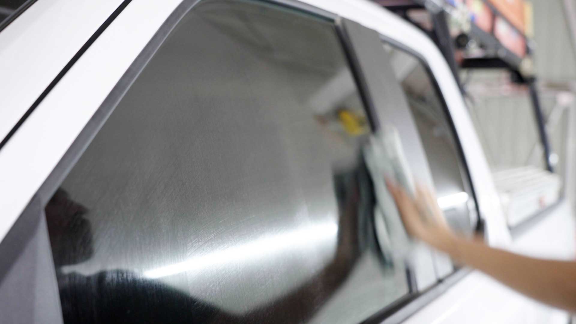 Skilled Vehicle Window Tint being cleaned after tinting in Bellmore