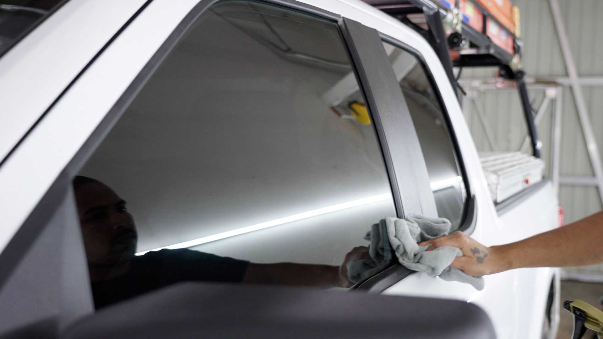 Skilled Vehicle Window Tint being cleaned after tinting in Riverview