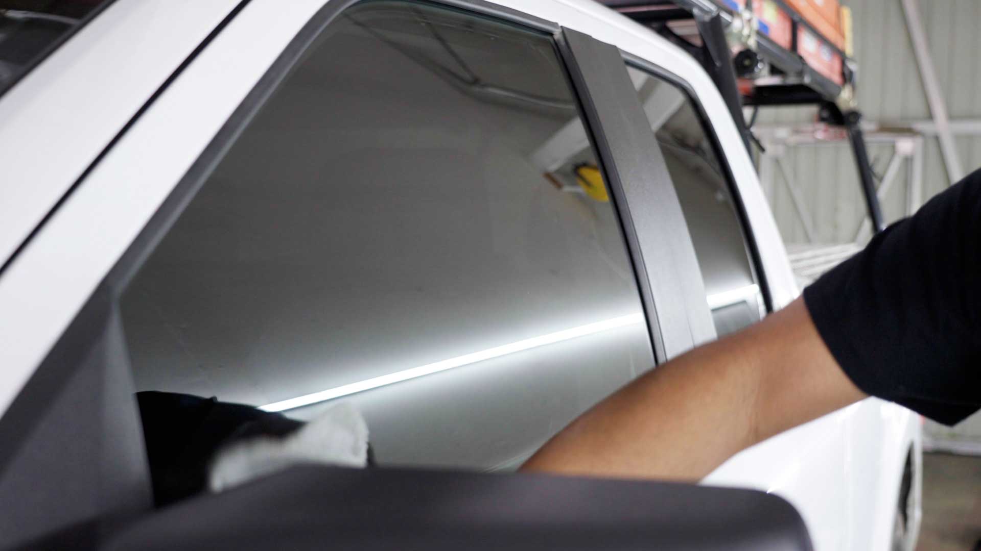 Skilled Car Window Tinting being cleaned after tinting in Addison
