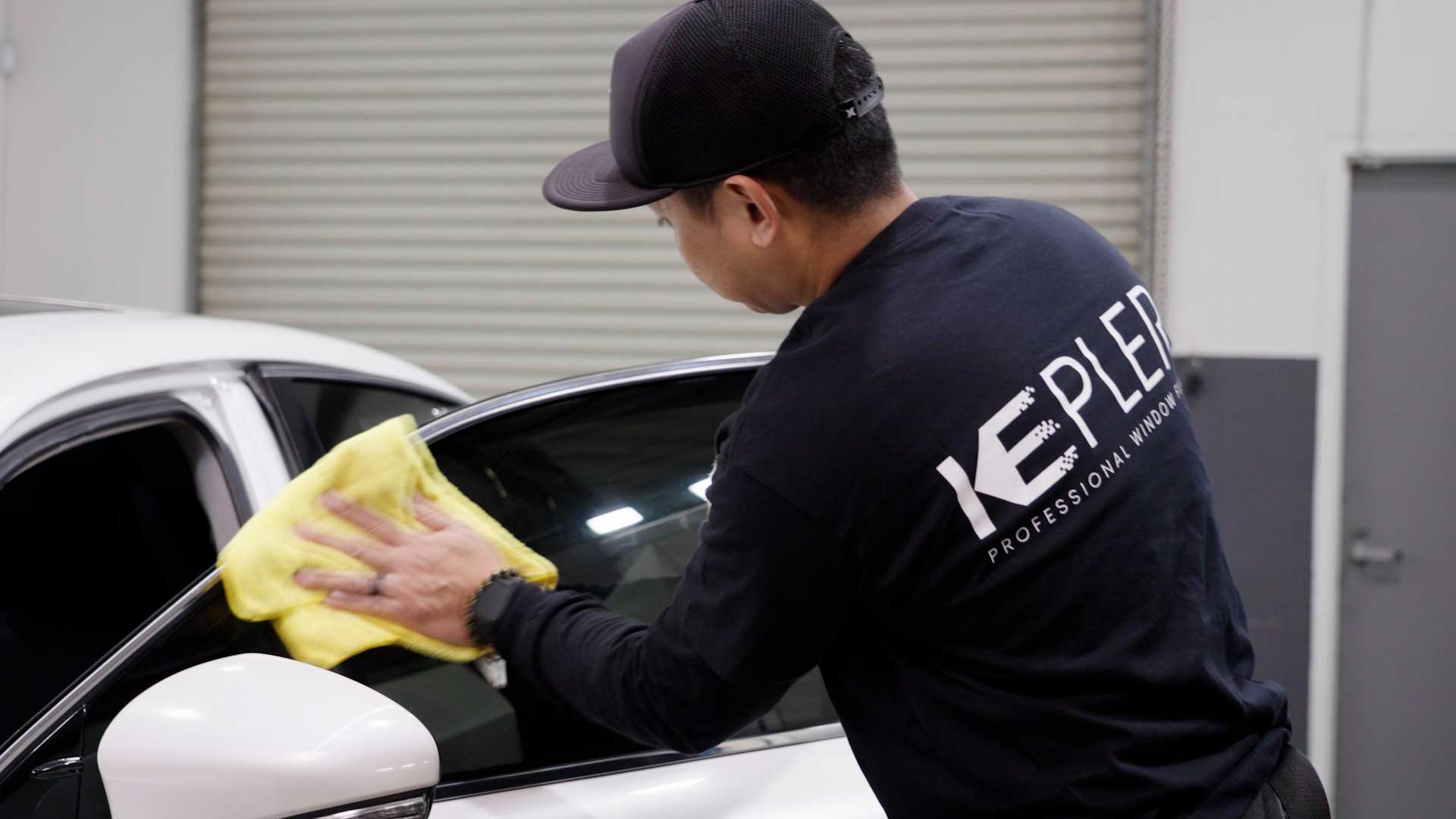 Skilled Vehicle Window Tint being cleaned after tinting in Middle Village