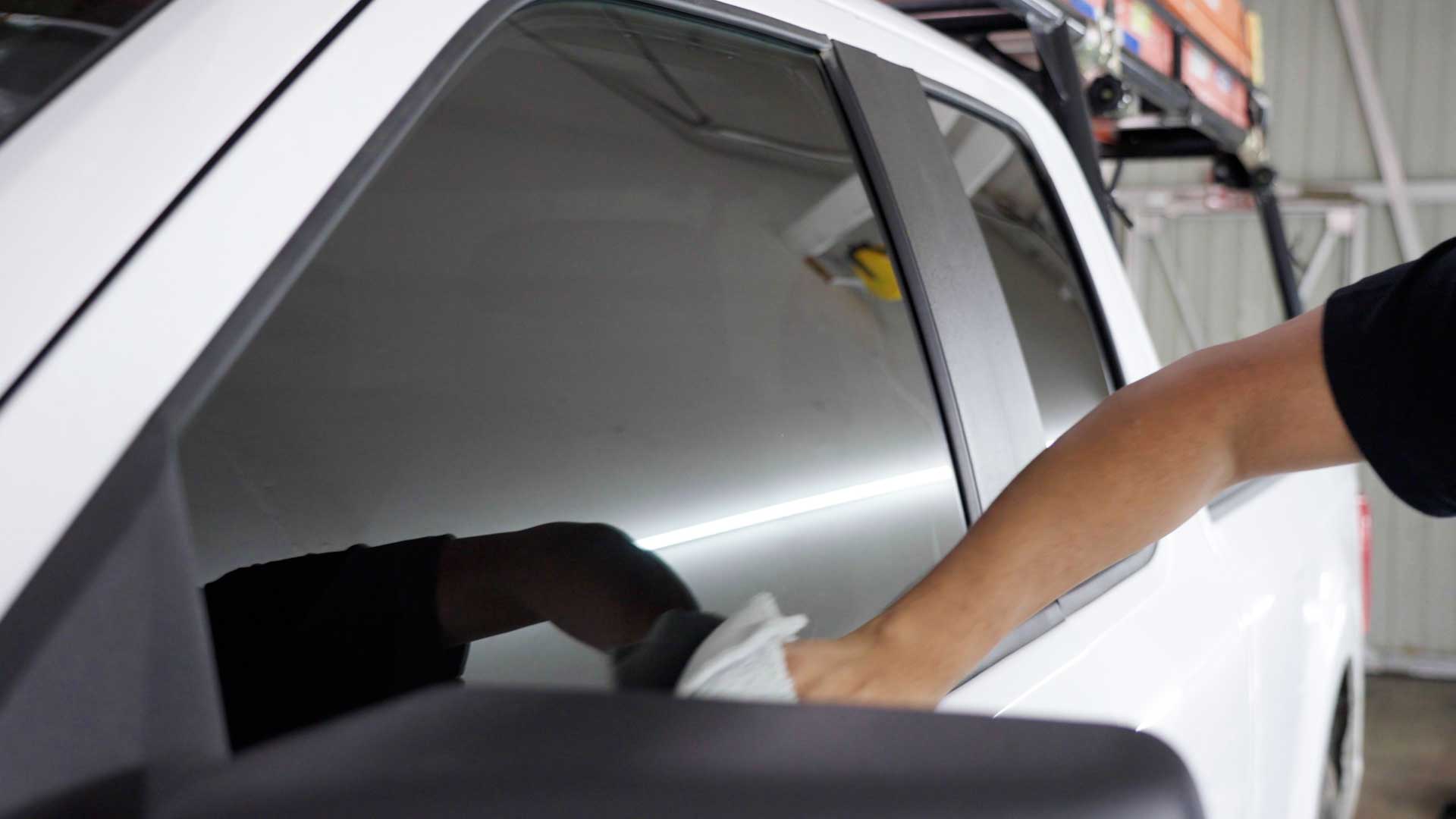 Professional Automotive Glass Tint being cleaned after tinting in Murray