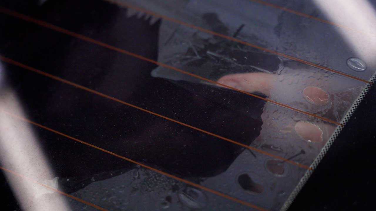 Professional removing window film to comply with CT tint laws