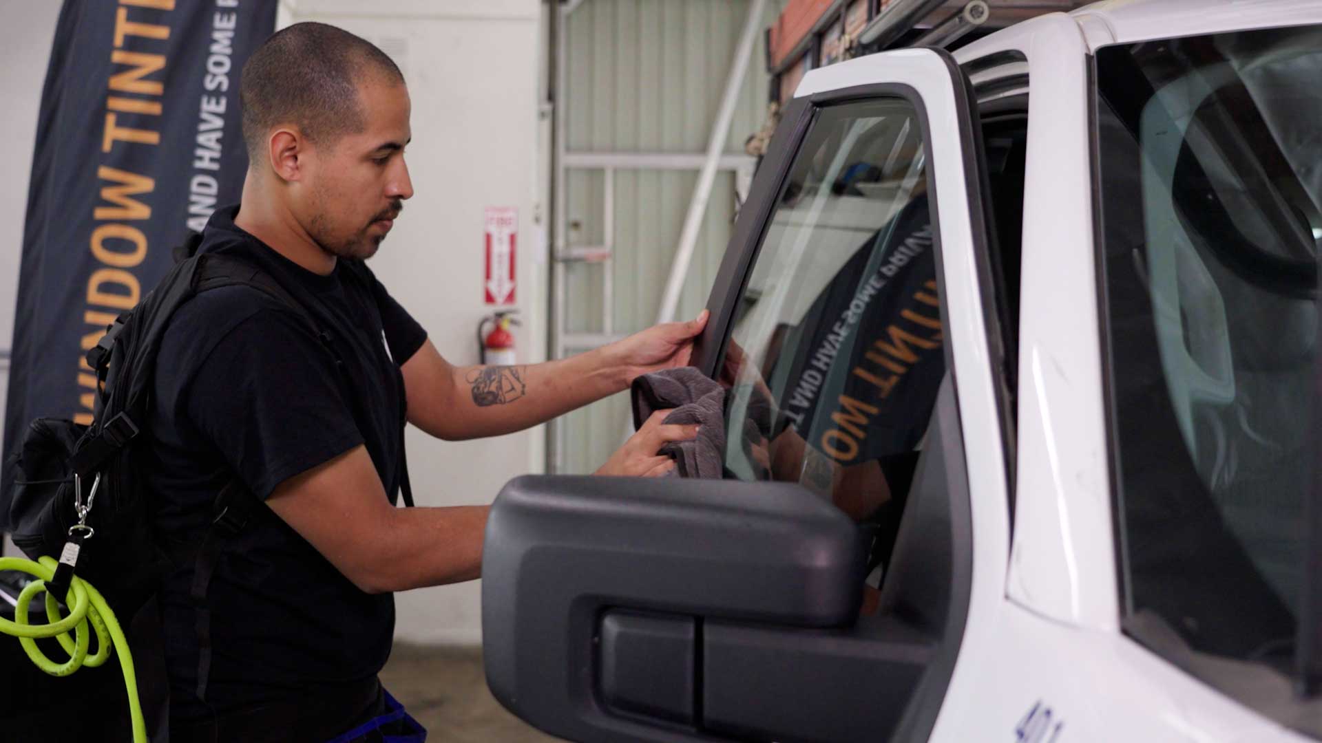 Skilled Vehicle Glass Tint being cleaned after tinting in Laguna Beach